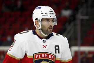 FILE - Florida Panthers' Keith Yandle (3) waits for a face-off against the Carolina Hurricanes during the second period of an NHL hockey game in Raleigh, N.C., in this Tuesday, April 6, 2021, file photo. A person with knowledge of the situation tells The Associated Press the Florida Panthers are buying out the remainder of veteran defenseman Keith Yandle’s contract. Yandle was signed for two more seasons at a salary cap hit of $6.35 million. The 34-year-old holds the longest active ironman streak in the NHL at 922 consecutive regular-season games played. (AP Photo/Karl B DeBlaker, File)