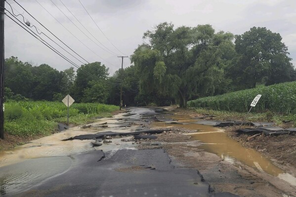 This photo provided by Jersey Central Power & Light shows flooding along Snyder Road, in Phillipsburg, N.J., near the intersection with county Route 519, Sunday, July 16, 2023. (Courtesy of JCP&L via AP)