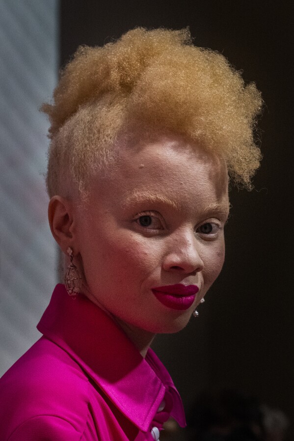 A model displays a garment donated by selected designers for the "Design for Life" showcase opening the Johannesburg Fashion Week 2023 in Johannesburg, South Africa, Wednesday, Nov. 8, 2023. The primary objective of this show was to raise awareness for breast cancer, and many of the models were breast cancer survivors. (AP Photo/Jerome Delay)