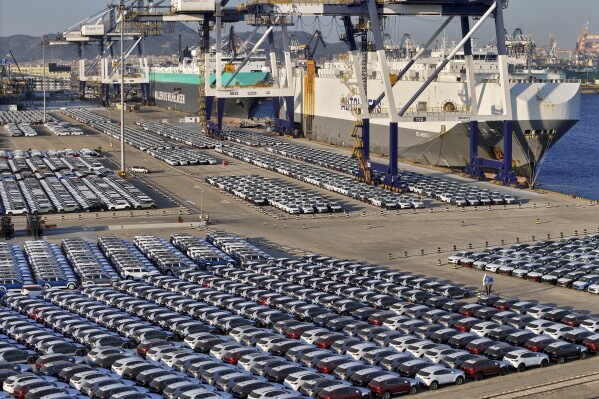 FILE - New cars for export wait for transportation on a vehicles carrier vessel at a dockyard in Yantai in east China's Shandong province on Nov. 2, 2023. Chinese auto sales slumped in June, 2024 as the domestic economy remains weak, but strong exports kept overall sales growth in positive territory, an industry association said Wednesday, July 10, 2024. (Chinatopix via AP, File)