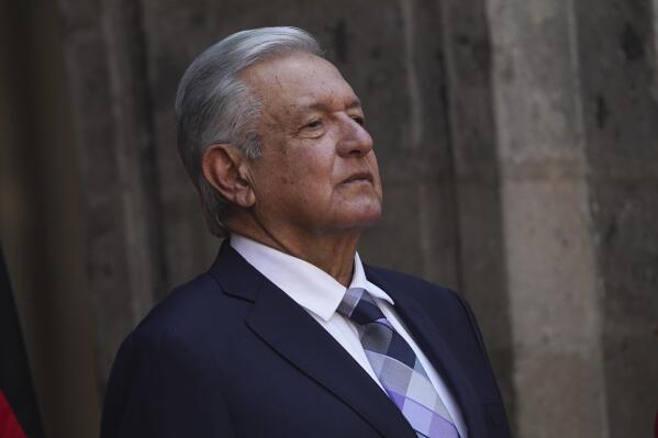 FILE - Mexican President Andres Lopez Obrador stands at the National Palace during a welcome ceremony for Germany's President Frank-Walter Steinmeier in Mexico City,, Sept. 20, 2022. López Obrador said Friday, Oct. 7 he has chosen the head of the country’s tax agency to fill the cabinet-level post of secretary of the economy.  (AP Photo/Marco Ugarte, File)