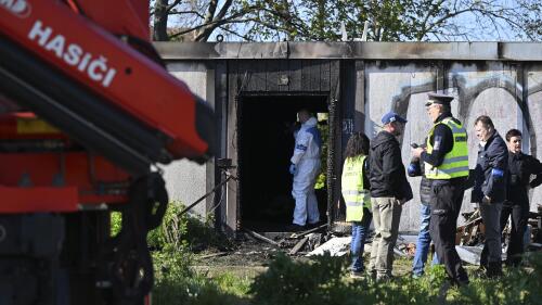 Firefighters and police investigators gather at the scene of a fatal fire in Plotni Street in Brno, Czech Republic, Thursday, May 4, 2023. Eight people have died in an overnight fire in the second largest city in the Czech Republic, police said Thursday. (Vaclav Salek/CTK via AP)