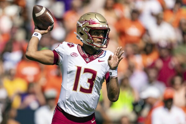 Florida State quarterback Jordan Travis throws a pass during the first half of an NCAA college football game against Clemson, Saturday, Sept. 23, 2023, in Clemson, S.C. (AP Photo/Jacob Kupferman)