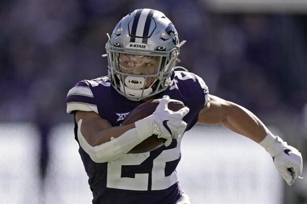 FILE - Kansas State running back Deuce Vaughn runs the ball during the first half of an NCAA college football game against TCU, Saturday, Oct. 30, 2021, in Manhattan, Kan. Vaugh was named to The Associated Press preseason All-America team, Monday, Aug. 22, 2022. (AP Photo/Charlie Riedel, File)