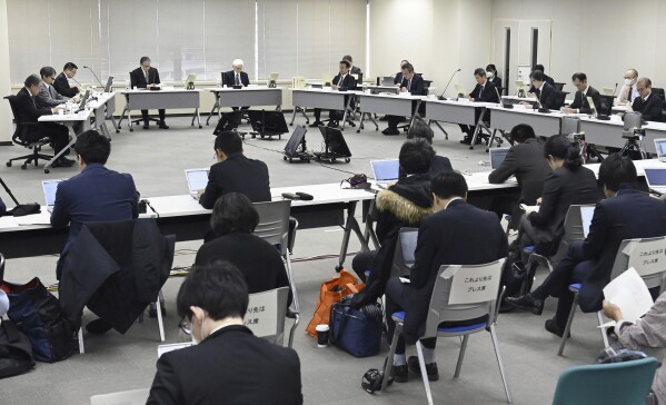 Members of Japan's Nuclear Regulation Authority attend a meeting in Tokyo Wednesday, Dec. 27, 2023. Japanese nuclear safety regulators lifted an operational ban Wednesday, Dec. 27, 2023, imposed on Tokyo Electric Power Company Holdings, also known as TEPCO, the operator behind the Fukushima plant that ended in disaster, allowing the company to resume preparations for restarting the Kashiwazaki-Kariwa, a separate plant, after a 12-year stoppage. (Kyodo News via AP)