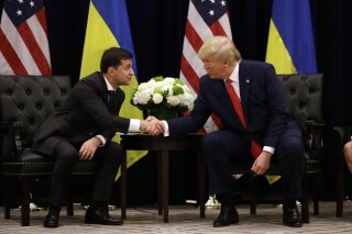 FILE - In this Wednesday, Sept. 25, 2019 file photo, President Donald Trump meets with Ukrainian President Volodymyr Zelenskiy at the InterContinental Barclay New York hotel during the United Nations General Assembly in New York. The House impeachment inquiry is zeroing in on two White House lawyers privy to a discussion about moving a memo recounting President Donald Trump’s phone call with the leader of Ukraine into a highly restricted computer system normally reserved for documents about covert action.  (AP Photo/Evan Vucci, File)