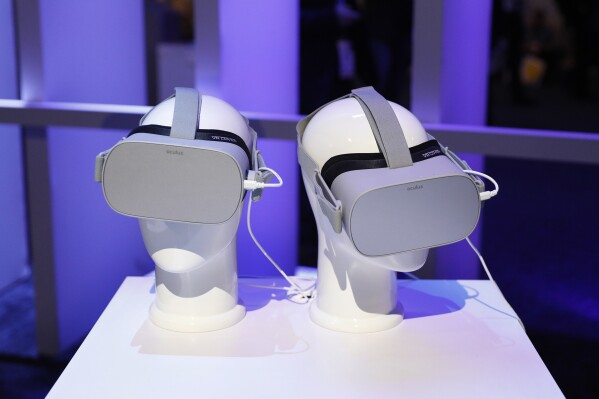 FILE - Oculus VR headsets sit on display at CES International on Jan. 8, 2019, in Las Vegas. The corporate parent of Facebook and Instagram plans to open a digital gateway for kids as young as 10 years old to enter virtual reality through the Meta Quest headset, according to a blog post Friday, June 16, 2023, despite rising concerns about children spending too much time on social media. (AP Photo/John Locher, File)