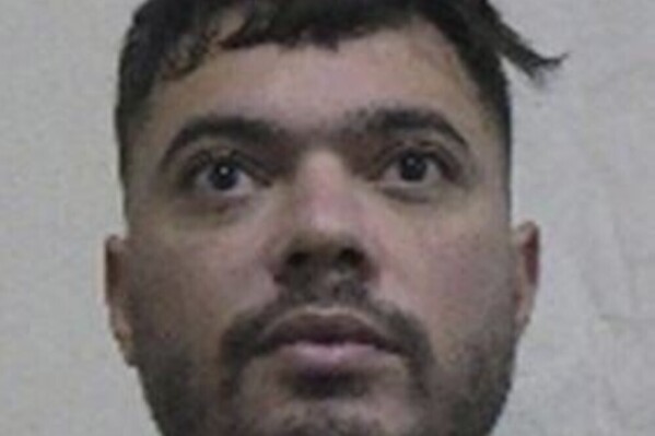 This picture provided by Interpol shows Mohamed Amra, a convict that escaped from prison on Tuesday. May 14, 2024. A massive manhunt is underway in France on Wednesday, May 15, 2024, for an armed gang that ambushed a prison convoy, killing two prison officers, seriously injuring three others and springing the inmate they were escorting. (Interpol via AP)