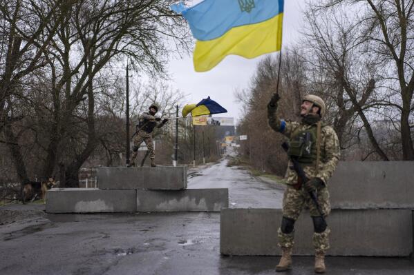 FILE - Ukrainian soldiers celebrate at a check point in Bucha, in the outskirts of Kyiv, Ukraine, April 3, 2022. Kyiv was a Russian defeat for the ages. It started poorly for the invaders and went downhill from there.  (AP Photo/Rodrigo Abd, File)