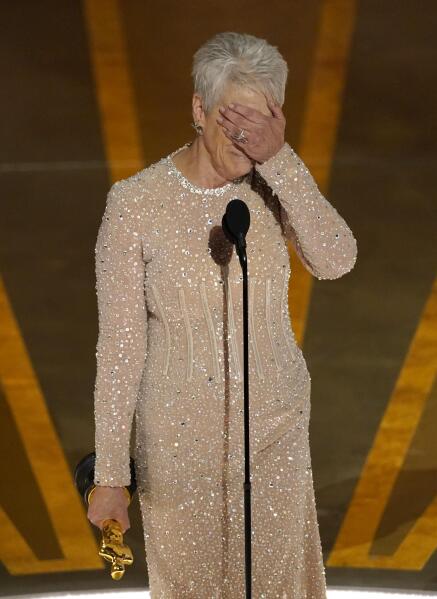 Jamie Lee Curtis reacts as she accepts the award for best performance by an actress in a supporting role for "Everything Everywhere All at Once" at the Oscars on Sunday, March 12, 2023, at the Dolby Theatre in Los Angeles. (AP Photo/Chris Pizzello)
