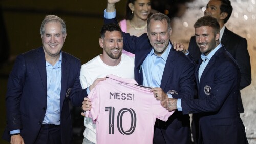 Inter Miami's Lionel Messi, center left, holds his new Inter Miami team jersey as he poses with team co-owners Jorge Mas, left, Jose Mas, second right, and David Beckham during a celebration by the team at DRV PNK Stadium, Sunday, July 16, 2023, in Fort Lauderdale, Fla. It comes one day after Messi, Major League Soccer and Inter Miami finalized his signing through the 2025 season. His first official training session is Tuesday and he is expected to play Friday in a Leagues Cup match against Cruz Azul. (AP Photo/Rebecca Blackwell)