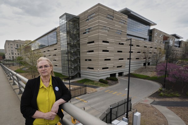 IRS customer service representative Shannon Ellis, stands outside a processing center where hundreds of her colleagues have taken buyouts and others face potential layoffs, Monday, April 14, 2025, in Kansas City, Mo. (AP Photo/Charlie Riedel)