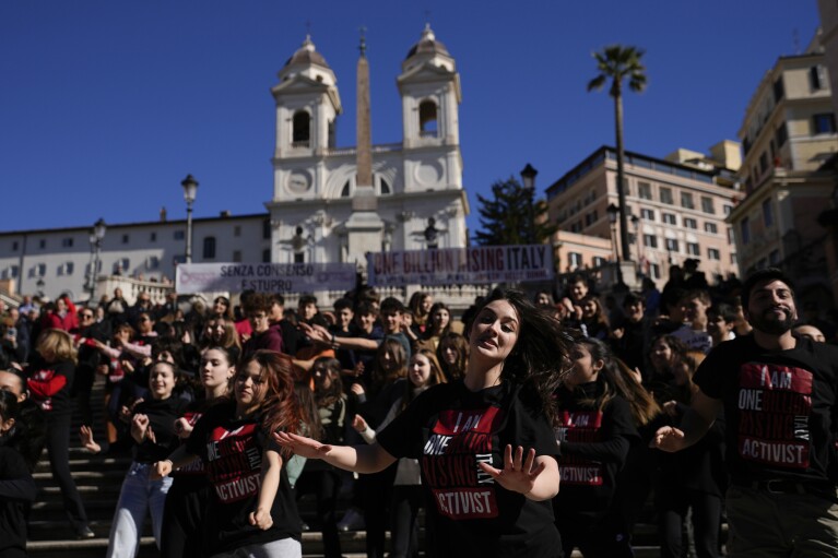 Activists perform during a "One Billion Rising" event at the Rome's Spanish Steps during a flash mob on Valentine's Day in Rome, Wednesday, Feb. 14, 2024. The global campaign "One Billion Rising" calls for an end to violence against women and girls. (AP Photo/Alessandra Tarantino)