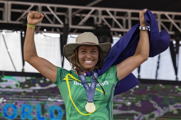 Sally Fitzgibbons of Australia, celebrates winning the gold medal at the final of the ISA World Surfing Games, a qualifier for the Paris 2024 Olympic Games, at La Marginal beach in Arecibo, Puerto Rico, Sunday, March. 3, 2024. (AP Photo/Alejandro Granadillo)