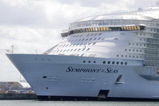 FILE - The Symphony of the Seas cruise ship is shown docked at PortMiami, in a Wednesday, May 20, 2020, file photo, in Miami. Cruise lines can soon begin trial voyages in U.S. waters. They'll have to carry some volunteer passengers, who will have to wear face masks and observe social distancing while on board. The Centers for Disease Control and Prevention gave ship operators final technical guidelines Wednesday, May 5, 2021 for the trial runs. (AP Photo/Wilfredo Lee, File)
