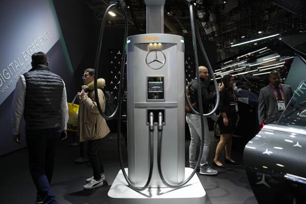 A ChargePoint electric vehicle charging hub, center, is on display at the Mercedes-Benz booth during the CES tech show Thursday, Jan. 5, 2023, in Las Vegas. Mercedes-Benz says it will build its own worldwide electric vehicle charging network starting in North America in a bid to compete with EV sales leader Tesla. (AP Photo/John Locher)