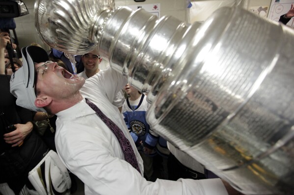 FILE - Pittsburgh Penguins coach Dan Bylsma drinks from the Stanley Cup after the Penguins defeated the Detroit Red Wings 2-1 to win Game 7 of the NHL hockey Stanley Cup Finals in Detroit, June 12, 2009. After making it to the Stanley Cup Final in 2008, the Penguins were barely over .500 in February of the next season, leading GM Ray Shero to fire Michel Therrien and promote Bylsma from the AHL. The results were almost immediate. (AP Photo/Paul Sancya, File)