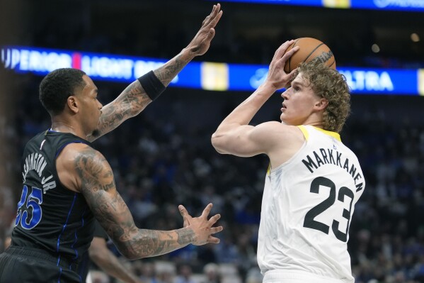 FILE - Utah Jazz forward Lauri Markkanen (23) looks for an opening against Dallas Mavericks defender P.J. Washington (25) during an NBA basketball game in Dallas, March 21, 2024. (AP Photo/LM Otero, File)