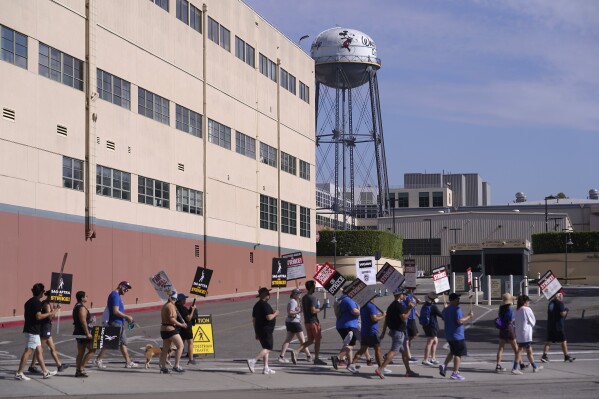 Picketers demonstrate outside Disney studios on Friday, July 28, 2023, in Burbank, Calif. The actors strike comes more than two months after screenwriters began striking in their bid to get better pay and working conditions. (AP Photo/Damian Dovarganes)