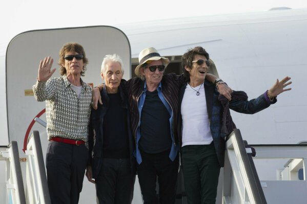 FILE - In this March 24, 2016 file photo, members of The Rolling Stones, from left, Mick Jagger, Charlie Watts, Keith Richards and Ron Wood pose for photos from the plane that brought them to Cuba ...