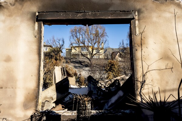 A home destroyed by the Eaton Fire stands in front a home that survived in Altadena. Calif., on Monday, Jan. 13, 2025. (AP Photo/Noah Berger)