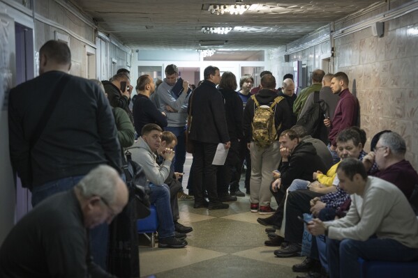 Recruits wait for their turn to pass medical examination in a city hospital in Kyiv, Ukraine, Thursday, Feb. 8, 2024. As the third year of war begins, the most sensitive and urgent challenge pressing on Ukraine is whether it can muster enough new soldiers to repel – and eventually drive out – an enemy with far more fighters at its disposal. (AP Photo/Efrem Lukatsky)