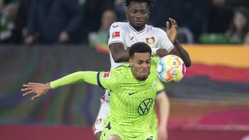 FILE - Wolfsburg's Felix Nmecha, front, and Leverkusen's Edmond Tapsoba challenge for the ball during the German Bundesliga soccer match between VfL Wolfsburg and Bayer 04 Leverkusen in Wolfsburg, Germany, Sunday, April 16, 2023. Borussia Dortmund said in a statement Monday, July 3, 2023 it has signed midfielder Felix Nmecha from league rival Wolfsburg despite misgivings over homophobic and transphobic social media posts that the player shared. (Swen Pfoertner/dpa via AP, File)