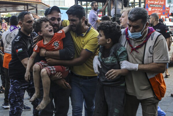 Wounded Palestinian children arrive to Shifa Hospital, following Israeli airstrikes on Gaza City, central Gaza Strip, Tuesday, Oct. 17, 2023. (AP Photo/Abed Khaled)
