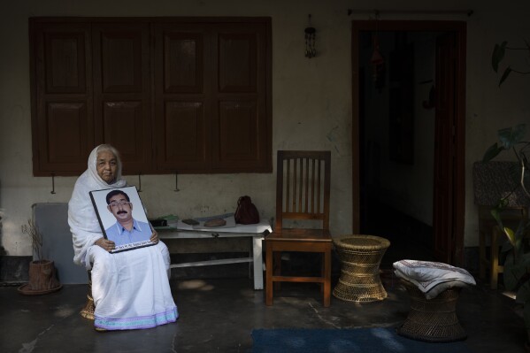 Hazera Khatun, 70, holds a portrait of her son Sajedul Islam Sumon, a BNP local politician who has been missing for over 10 years, in Dhaka, Bangladesh, Thursday, Jan. 4, 2024. Khatun founded Mayer Daak, or Mother's Call, a platform for family members of victims of enforced disappearances in Bangladesh after the disappearance of her son. In August, Human Rights Watch said Bangladesh's security forces have committed over 600 enforced disappearances since 2009, when prime minister Sheikh Hasina came to power for the second time. (AP Photo/Altaf Qadri)