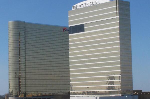 The exterior of the Borgata casino, left, and its Water Club hotel, right, are seen Oct. 1, 2020. On Sept. 28, 2022, a New York man sued the Borgata, its parent company and an online betting partner, alleging they paid him $30,000 a month not to report regular malfunctions of online games that caused him to be disconnected and lose out on winning hands. (AP Photo/Wayne Parry)