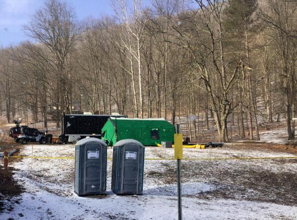 FILE - FBI agents and representatives of the Pennsylvania Department of Conservation and Natural Resources set up a base in March, 2018, in Benezette Township, Elk County, Pa. A scientific report commissioned by the FBI shortly before agents went digging for buried treasure suggested that a huge quantity of gold was below the surface, according to newly released government documents. (Katie Weidenboerner/The Courier-Express via AP, File)