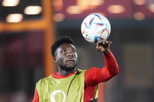 Canada forward Alphonso Davies plays with the ball during practice at the World Cup soccer tournament in Doha, Qatar, Tuesday, Nov. 22, 2022. (Nathan Denette/The Canadian Press via AP)
