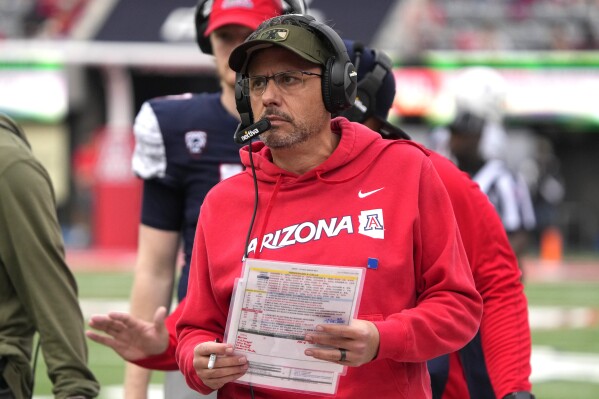 Arizona head coach Jedd Fisch watches the clock during the second half of an NCAA college football game against Utah, Saturday, Nov. 18, 2023, in Tucson, Ariz. (AP Photo/Rick Scuteri)