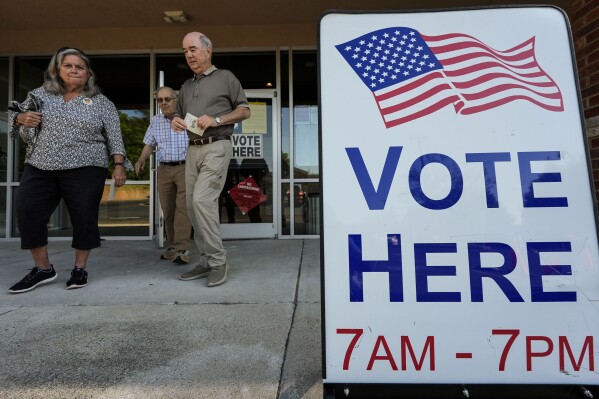 FILE - Voters depart an election center during primary voting, May 21, 2024, in Kennesaw, Ga. (AP Photo/Mike Stewart, File)