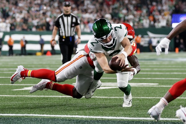 New York Jets quarterback Zach Wilson (2) reaches across the goal line as he is tackled by Kansas City Chiefs linebacker Willie Gay (50) to score a two-point conversion during the third quarter of an NFL football game, Sunday, Oct. 1, 2023, in East Rutherford, N.J. (AP Photo/Adam Hunger)