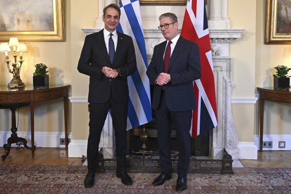 Britain's Prime Minister Keir Starmer, right, and Greece's Prime Minister Kyriakos Mitsotakis, left, pose for a photograph ahead of their meeting inside of 10 Downing Street in London, England, Tuesday, Dec. 3, 2024. (Justin Tallis/Pool Photo via AP)