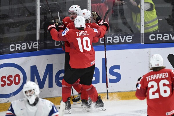 Switzerland's Thierry Schild celebrates scoring with teammates during the IIHF World Junior Championship group B ice hockey match between Switzerland and Norway at Frolundaborg arena in Gothenburg, Sweden, Saturday Dec. 30, 2023. (Bjorn Larsson Rosvall/TT News Agency via AP)