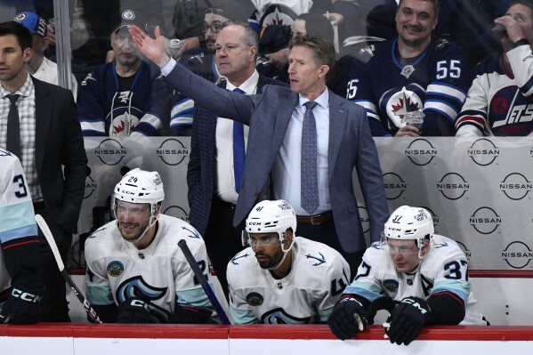 Seattle Kraken head coach Dave Hakstol motions to pull his goaltender against the Winnipeg Jets during the third period of an NHL hockey game in Winnipeg, Manitoba on Tuesday April 16, 2024. (Fred Greenslade/The Canadian Press via AP)