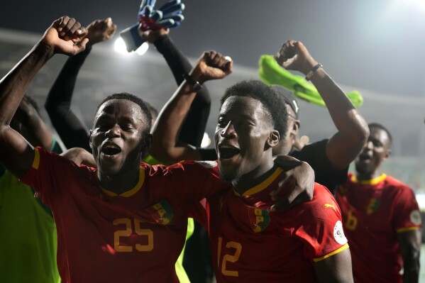 Guinea's Facinet Conte, left, with teammate Ibrahima Diakite celebrate at the end of the African Cup of Nations Group C soccer match between Guinea and Gambia, at the Charles Konan Banny stadium in Yamoussoukro, Ivory Coast, Friday, Jan. 19, 2024. (AP Photo/Sunday Alamba)