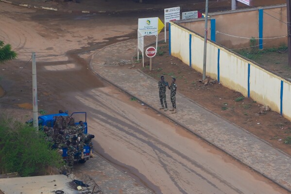 Nigerien gendarmes provide security in Niamey, Niger, Saturday, July 29, 2023. The African Union has issued a 15-day ultimatum to the junta in Niger to reinstall the country's democratically elected government just as the coup leaders met with senior civil servants to discuss how they would run the country and as the U.S. and the European Union threatened sanctions against the regime. (AP Photo/Sam Mednick)