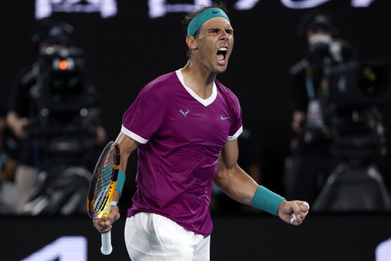 FILE - Rafael Nadal of Spain reacts after winning the third set against Daniil Medvedev of Russia during the men's singles final at the Australian Open tennis championships in Melbourne, Australia, Sunday, Jan. 30, 2022. Rafael Nadal says that he will return to playing at the Brisbane International in Australia in January. (AP Photo/Hamish Blair, File)