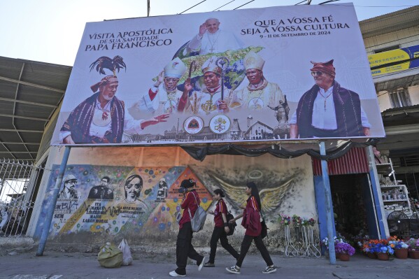 FILE - A billboard welcoming Pope Francis stands above a mural honoring Bishop Belo and three others as national heroes in Dili, East Timor, Aug. 14, 2024. (AP Photo/Achmad Ibrahim, File)