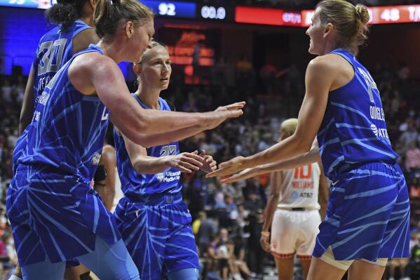 Chicago Sky guard Allie Quigley, right, congratulates teammates Emma Meesseman (33), Azurá Stevens (30), and Courtney Vandersloot (22) as they win in overtime over the Connecticut Sun in a WNBA basketball game in Uncasville, Conn., Sunday, July 31, 2022. (Sean D. Elliot/The Day via AP)