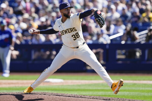 Milwaukee Brewers pitcher Devin Williams throws during the third inning of a spring training baseball game against the Los Angeles Dodgers, Saturday, March 2, 2024, in Phoenix. (AP Photo/Carolyn Kaster)