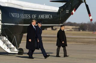 President Donald Trump escorted by Col. Brian Daniels walks to board Air Force One at Andrews Air Force Base, Md., Friday, Jan. 17, 2020, en route to his Mar-a-Lago estate, in Palm Beach, Fla. ( AP Photo/Jose Luis Magana)