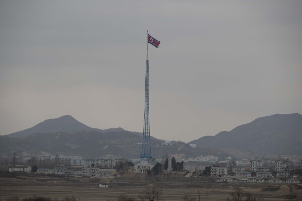 FILE - A North Korean flag flutters in North Korea's village Gijungdong as seen from an South Korea's observation post inside the demilitarized zone in Paju, South Korea during a media tour, March 3, 2023. North Korea confirmed Friday, Nov. 3, 2023 that it’s closing some of its diplomatic missions abroad, amid outside suspicions the steps are the latest sign of its economic troubles amid U.S.-led international sanctions. (Jeon Heon-Kyun/Pool Photo via AP, File)