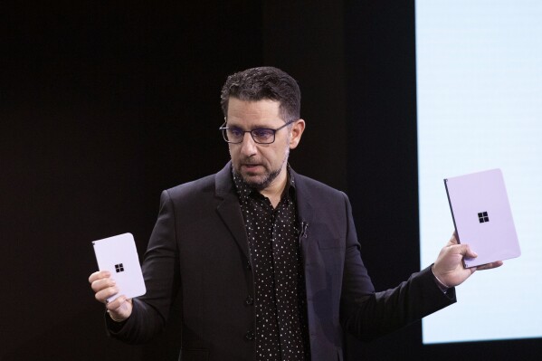 FILE - Microsoft's Chief Product Officer Panos Panay holds a Surface Duo, left, and Surface Neo at an event, Wednesday, Oct. 2, 2019, in New York. Panos Panay is stepping down after nearly 20 years at Microsoft, according to a staff memo Monday, Sept. 18, 2023. (AP Photo/Mark Lennihan, File)