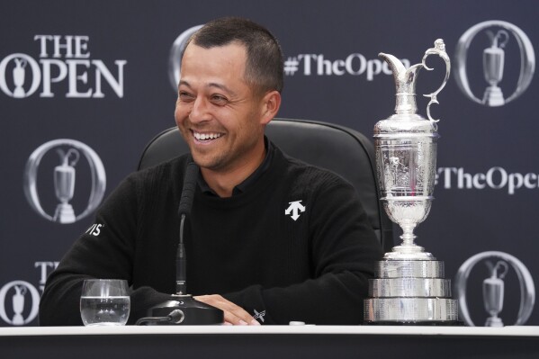 Xander Schauffele of the United States reacts as he sits with the Claret Jug trophy at a press conference after winning the British Open Golf Championships at Royal Troon golf club in Troon, Scotland, Sunday, July 21, 2024. (ĢӰԺ Photo/Jon Super)