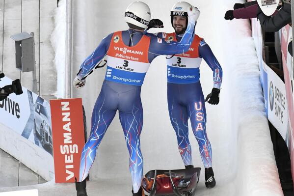 FILE - Chris Mazdzer, left, and Jayson Terdiman, of the United States, celebrate after competing in the men's double luge World Cup event on Saturday, Dec. 15, 2018, in Lake Placid, N.Y. USA Luge’s two-time doubles Olympian Jayson Terdiman announced Wednesday, Dec. 21, 2021, that this season will be his last. (AP Photo/Hans Pennink, File)