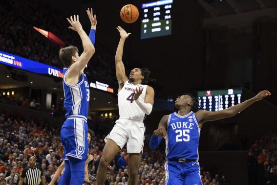 Virginia's Armaan Franklin (4) shoots the ball between Duke's Kyle Filipowski (30) and Mark Mitchell (25) during the second half of an NCAA college basketball game in Charlottesville, Va., Saturday, Feb. 11, 2023. (AP Photo/Mike Kropf)